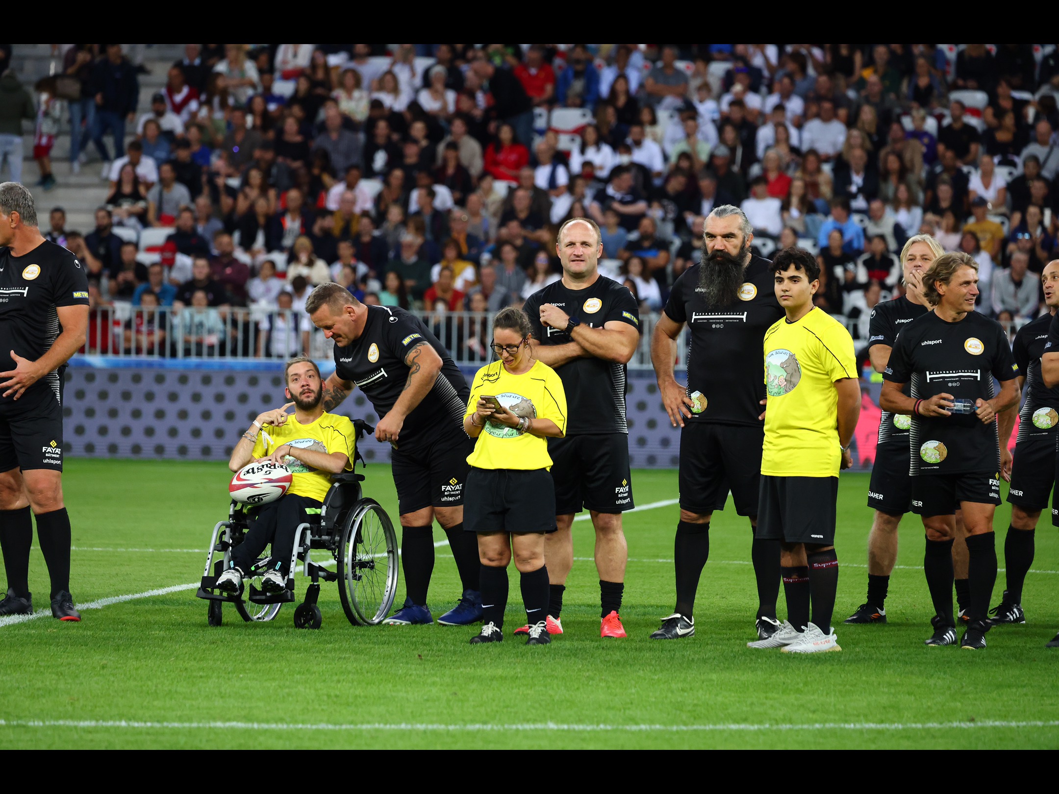 Kevin, Émeline et Paul entourés des rugbymen